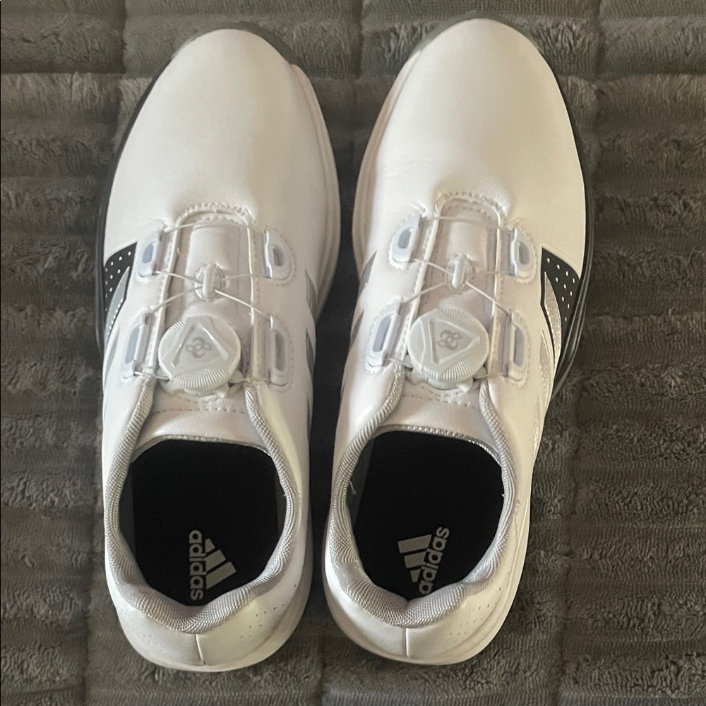 Adidas GolfShoes. These are youth size 5 which is equivalent 6.5 ladies.